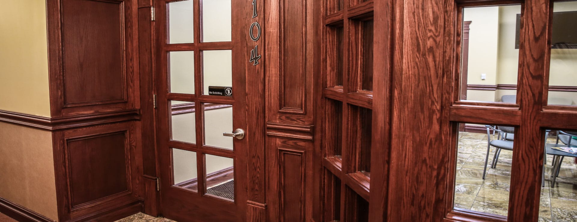 Entrance to clinic suite 104, with waiting-room chairs visible through the windows