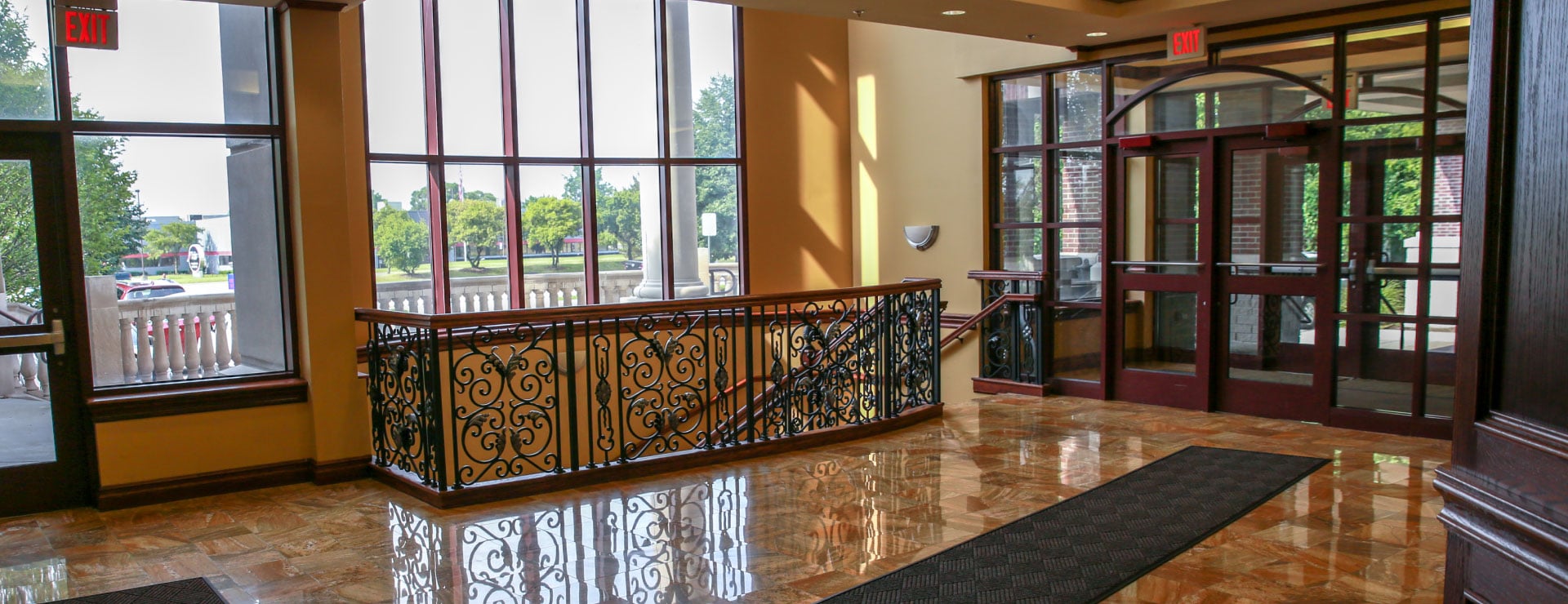 The building hallway outside the clinic, with windows and an entrance doorway